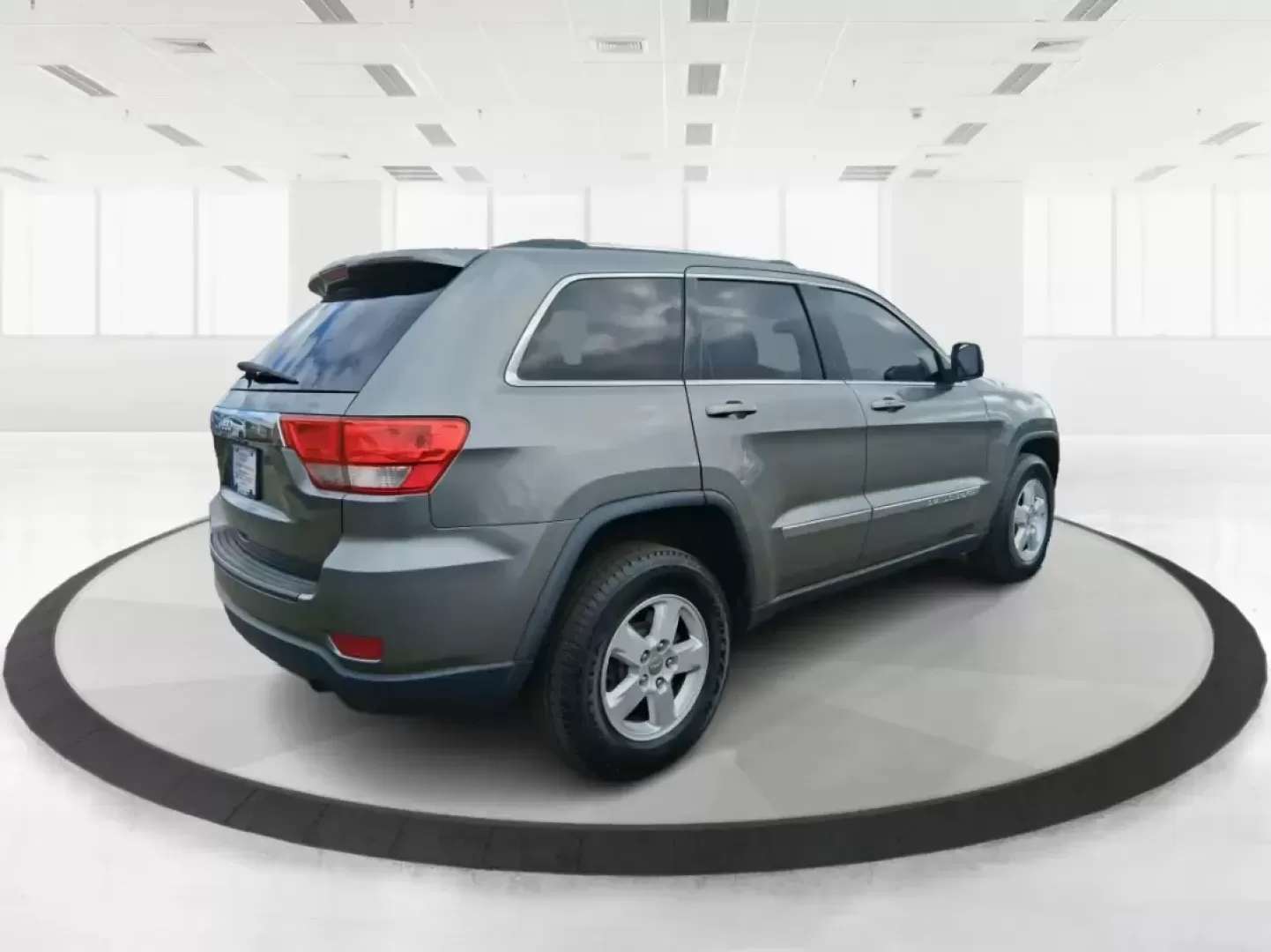 2013 Jeep Grand Cherokee Laredo (1C4RJFAG1DC) with an 3.6L V6 DOHC 24V engine, 5-Speed Automatic transmission, located at 401 Woodman Dr, Riverside, OH, 45431, (937) 908-9800, 39.760899, -84.123421 - Pack up the family, point the hood toward the next weekend getaway, and enjoy the confidence that comes with a capable SUV built for real life in Ohio. This 2013 Jeep Grand Cherokee Laredo in Mineral Gray Metallic Clearcoat is the kind of vehicle that fits your routine Monday through Friday-then tur - Photo#2