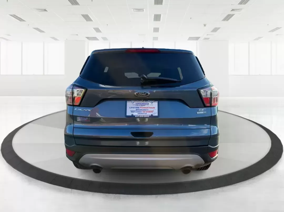 2018 Ford Escape SE (1FMCU9GD4JU) with an 1.5L L4 DOHC 16V engine, 6A transmission, located at 880 E. National Road, Vandalia, OH, 45377, (937) 908-9800, 39.891918, -84.183594 - Picture your next Ohio weekend: loading up the kids for a splash at Splash Xenia, cruising out to John Bryan State Park for a hike, or tackling a snowy morning commute from Beavercreek to downtown Dayton with confidence. This 2018 Ford Escape SE in Blue Metallic is the kind of compact SUV that fits - Photo#3