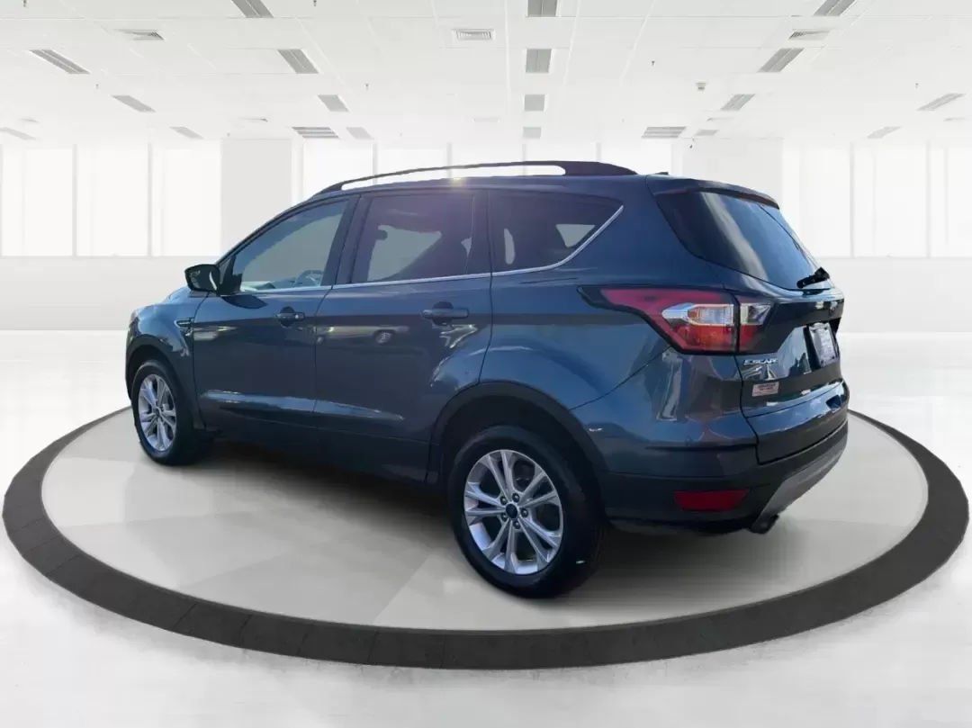 2018 Ford Escape SE (1FMCU9GD4JU) with an 1.5L L4 DOHC 16V engine, 6A transmission, located at 880 E. National Road, Vandalia, OH, 45377, (937) 908-9800, 39.891918, -84.183594 - Picture your next Ohio weekend: loading up the kids for a splash at Splash Xenia, cruising out to John Bryan State Park for a hike, or tackling a snowy morning commute from Beavercreek to downtown Dayton with confidence. This 2018 Ford Escape SE in Blue Metallic is the kind of compact SUV that fits - Photo#4