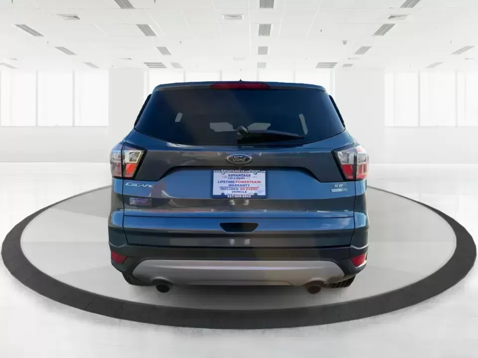 2018 Ford Escape SE (1FMCU9GD4JU) with an 1.5L L4 DOHC 16V engine, 6A transmission, located at 880 E. National Road, Vandalia, OH, 45377, (937) 908-9800, 39.891918, -84.183594 - Picture your next Ohio weekend: loading up the kids for a splash at Splash Xenia, cruising out to John Bryan State Park for a hike, or tackling a snowy morning commute from Beavercreek to downtown Dayton with confidence. This 2018 Ford Escape SE in Blue Metallic is the kind of compact SUV that fits - Photo#3