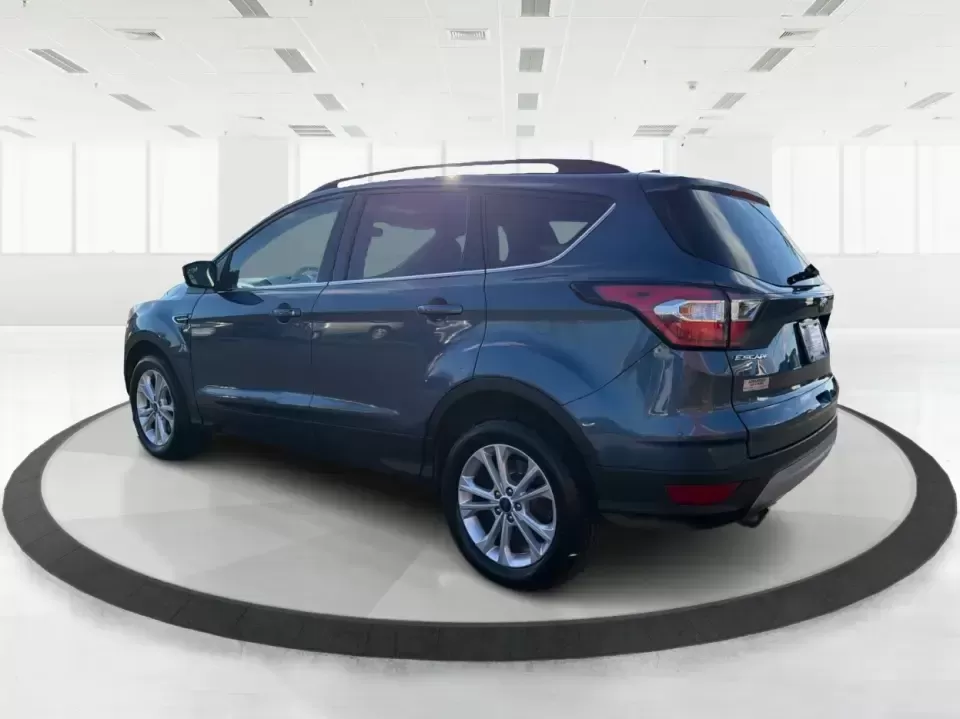 2018 Ford Escape SE (1FMCU9GD4JU) with an 1.5L L4 DOHC 16V engine, 6A transmission, located at 880 E. National Road, Vandalia, OH, 45377, (937) 908-9800, 39.891918, -84.183594 - Picture your next Ohio weekend: loading up the kids for a splash at Splash Xenia, cruising out to John Bryan State Park for a hike, or tackling a snowy morning commute from Beavercreek to downtown Dayton with confidence. This 2018 Ford Escape SE in Blue Metallic is the kind of compact SUV that fits - Photo#4