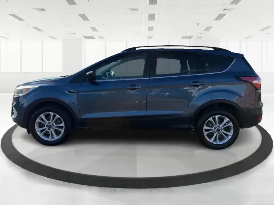 2018 Ford Escape SE (1FMCU9GD4JU) with an 1.5L L4 DOHC 16V engine, 6A transmission, located at 880 E. National Road, Vandalia, OH, 45377, (937) 908-9800, 39.891918, -84.183594 - Picture your next Ohio weekend: loading up the kids for a splash at Splash Xenia, cruising out to John Bryan State Park for a hike, or tackling a snowy morning commute from Beavercreek to downtown Dayton with confidence. This 2018 Ford Escape SE in Blue Metallic is the kind of compact SUV that fits - Photo#5