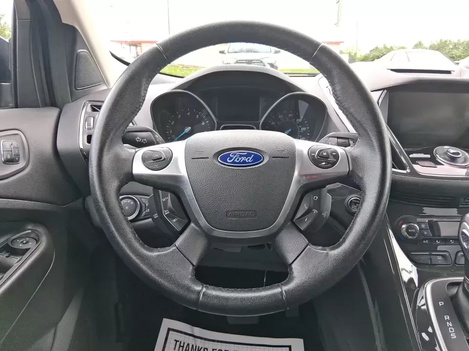 2014 Ford Escape Titanium (1FMCU9J99EU) with an 2.0L L4 DOHC 16V engine, 6-Speed Automatic transmission, located at 1099 N County Rd 25A , Troy, OH, 45373, (937) 908-9800, 40.057079, -84.212883 - Need one SUV that can handle an Ohio winter commute, school drop-offs, and a spontaneous weekend road trip to Hocking Hills without feeling like a compromise? This 2014 Ford Escape Titanium 4WD in sleek Tuxedo Black is built for real life in Troy-comfortable for long drives, confident in bad weather - Photo#16