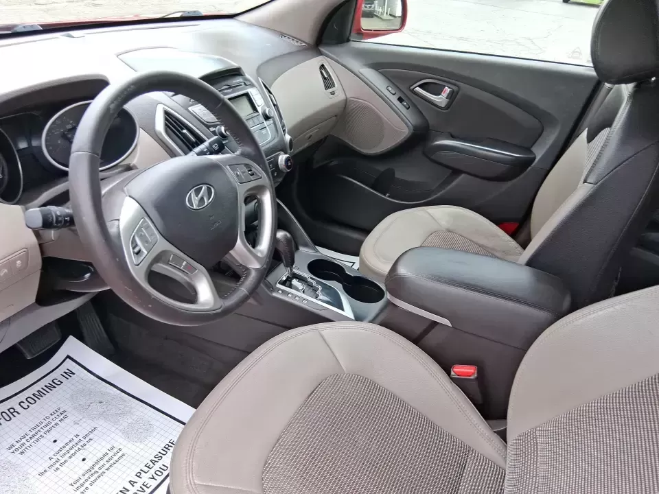 2013 Hyundai Tucson GLS (KM8JUCAC7DU) with an Theta II 2.4L I-4 DOHC engine, 6-Speed Automatic transmission, located at 8750 N County Rd 25A, Piqua, OH, 45356, (937) 908-9800, 40.164391, -84.232513 - Need a dependable SUV that can handle Ohio weather, school drop-offs, and weekend getaways without stretching your budget? This 2013 Hyundai Tucson GLS in eye-catching Garnet Red is built for real life-comfortable for daily commuting, confident on slick winter roads, and practical for everything fro - Photo#9