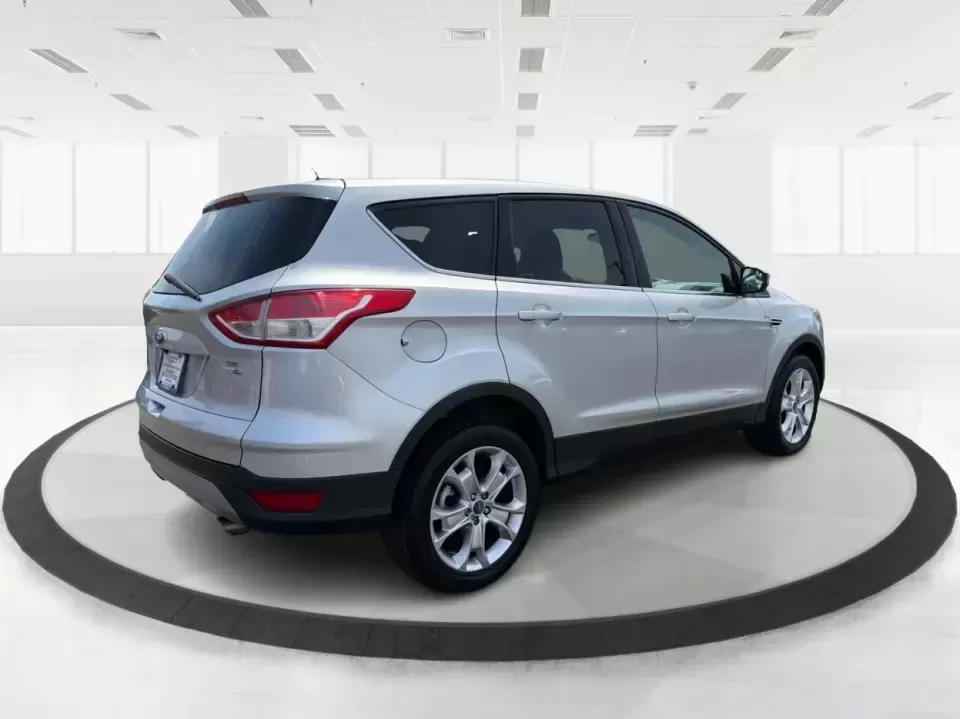 2015 Ford Escape SE (1FMCU9G98FU) with an 2.0L L4 DOHC 16V engine, 6-Speed Automatic transmission, located at 1099 N County Rd 25A , Troy, OH, 45373, (937) 908-9800, 40.057079, -84.212883 - Weekday commutes down I75, school drop-offs around Troy City Schools, and spontaneous weekend trips to Charleston Falls Preserve all get easier when you have an SUV that's the right size, the right power, and the right fit for your budget. This 2015 Ford Escape SE in Ingot Silver is built for real-l - Photo#2