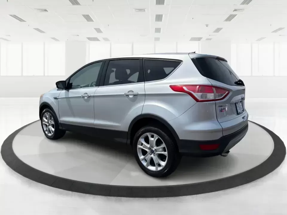 2015 Ford Escape SE (1FMCU9G98FU) with an 2.0L L4 DOHC 16V engine, 6-Speed Automatic transmission, located at 1099 N County Rd 25A , Troy, OH, 45373, (937) 908-9800, 40.057079, -84.212883 - Weekday commutes down I75, school drop-offs around Troy City Schools, and spontaneous weekend trips to Charleston Falls Preserve all get easier when you have an SUV that's the right size, the right power, and the right fit for your budget. This 2015 Ford Escape SE in Ingot Silver is built for real-l - Photo#4